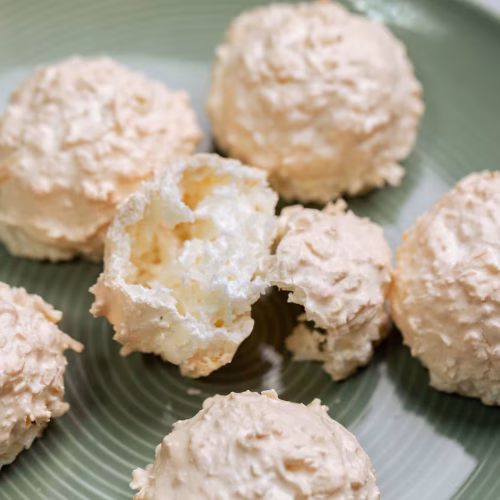 Galleta de coco | Pastelería Ciro Guatemala | Crujientes galletas de merengue artesanal con coco rallado tostado, ligeras y de sabor delicado. Elaboradas con clara de huevo y azúcar batidos a punto de nieve y horneadas lentamente para lograr una textura aireada que se deshace en la boca.